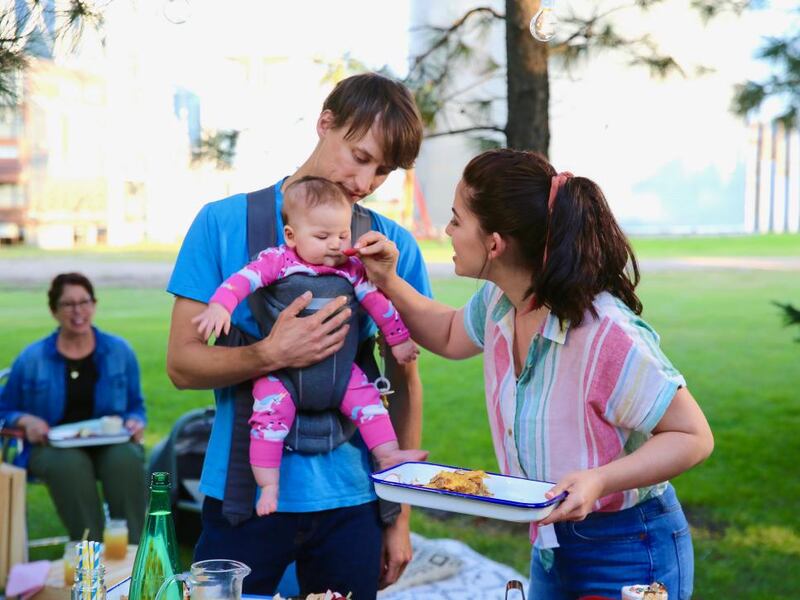 Molly Yeh gives her daughter a snack during outdoor movie night on the farm.