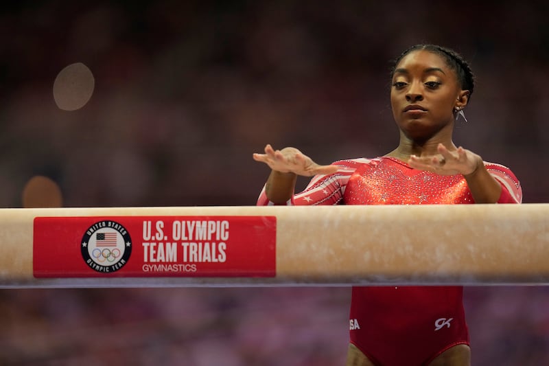 Simone Biles prepares to perform on the beam at the women’s U.S. Olympic Gymnastics Trials.