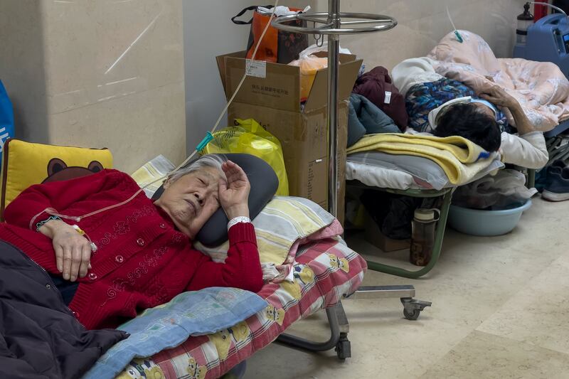 Elderly patients rest along a corridor of the emergency ward as they receive intravenous drips in Beijing.