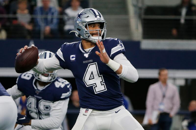 In this Dec. 15, 2019, file photo, Dallas Cowboys quarterback Dak Prescott (4) looks to throw in the first quarter of an NFL football game against the Los Angeles Rams in Arlington, Texas.