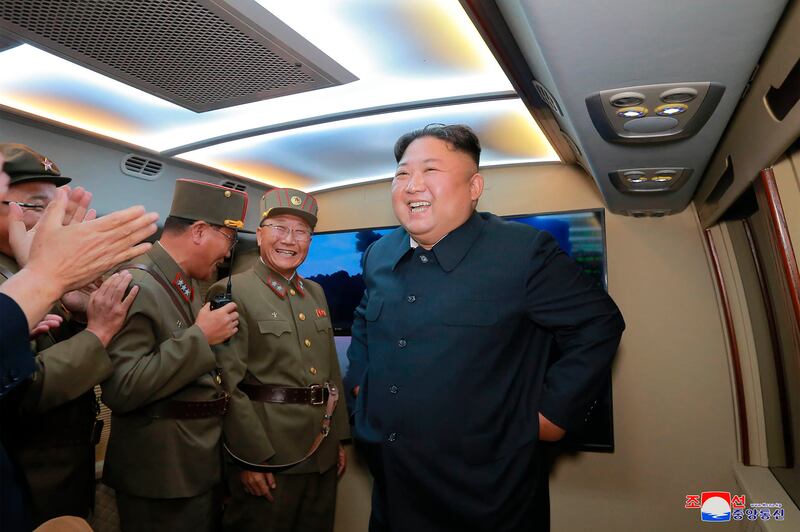In this Tuesday, Aug. 6, 2019, photo provided by the North Korean government, North Korean leader Kim Jong Un, right, visits an airfield in the western area of North Korea to watch its weapons demonstrations. North Korea continued to ramp up its weapons d