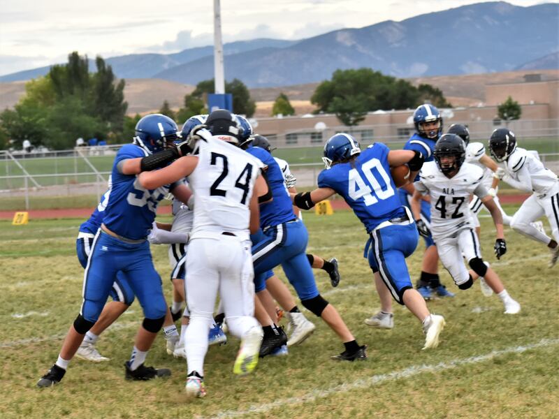 Football players make tackles