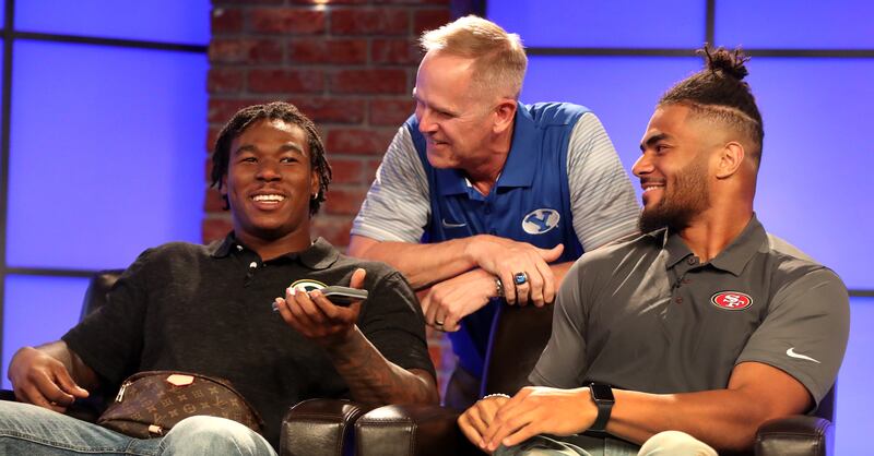 NFL running back Jamaal Williams, BYU athletic director Tom Holmoe and NFL linebacker Fred Warner talk on a BYUtv set in 2018.