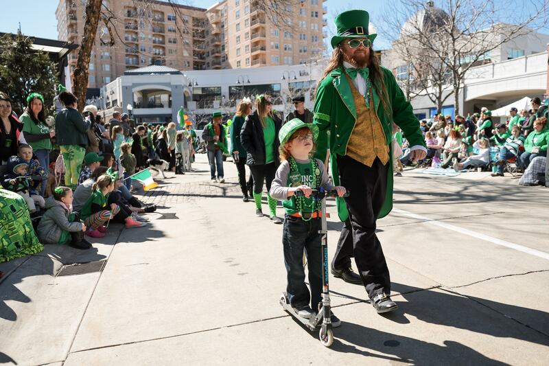 Patrick Gallagher walks with his son, Finn, 5, in the St. Patrick’s Day parade at The Gateway in Salt Lake City.