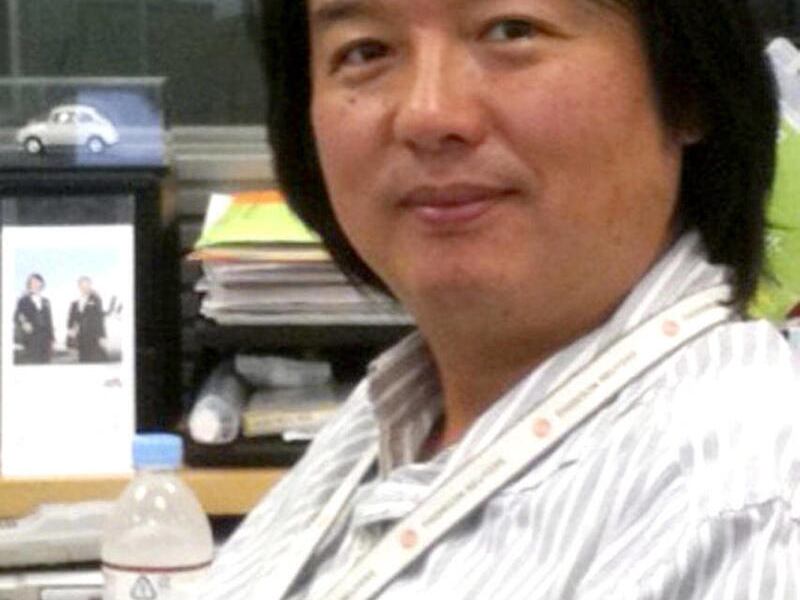 FILE - In this undated file photo released by Reuters, Japanese TV cameraman Hiro Muramoto smiles at his office in Tokyo. Thailand's Department of Special Investigation said Monday, Feb. 28, 2011 it has determined that Reuters journalist Muramoto who was