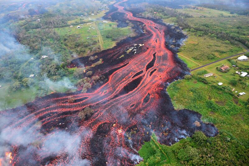 In this Saturday, May 19, 2018 file photo, released by the U.S. Geological Survey, lava flows from fissures near Pahoa, Hawaii. A year after a Hawaii volcano rained lava and gases on a rural swath of the Big Island in one of its largest eruptions in recor