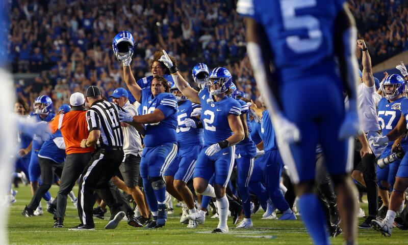 BYU players rush the field after beating No. 9 Baylor in double overtime at LaVell Edwards Stadium in Provo, Sept. 11, 2022.