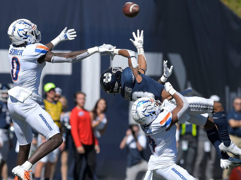 Boise State safety JL Skinner (0) and safety Rodney Robinson break up a pass intended for Utah State wide receiver Deven Thompkins (13).