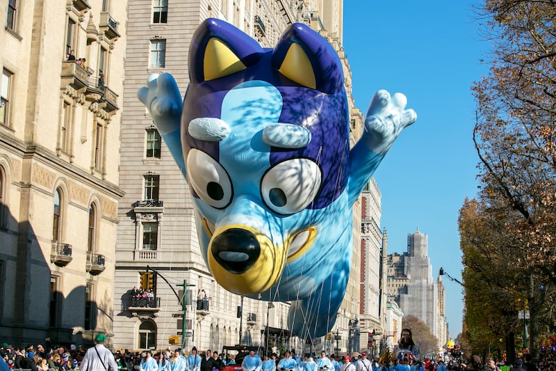 The Bluey balloon floats on Central Park West in New York City during Macy’s Thanksgiving Day Parade.