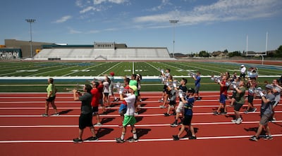 The Farmington High School marching band practices on the track at the new school on Thursday, July 12, 2018.