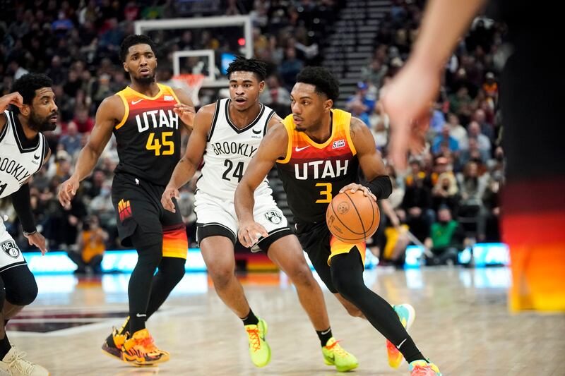 Utah Jazz guard Trent Forrest, wearing black, drives to the basket.