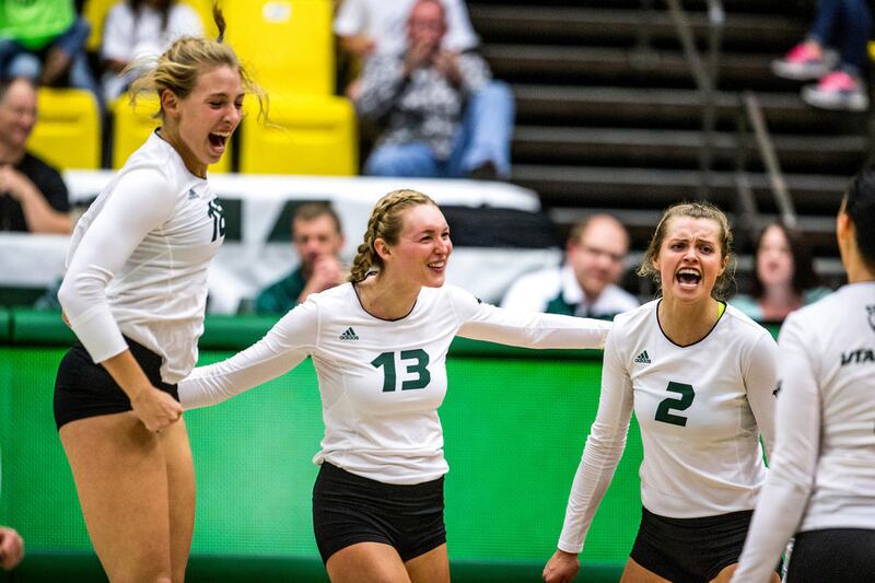 Madison Dennison (left), Kelcee Munk (left-center), Sierra Starley (right-center) and Marija Martinovic (right) celebrate during a match against the New Mexico State University Aggies on Oct. 20.