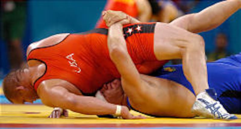 Rulon Gardner, left, wrestles Serguey Moreiko, of Bulgaria, during a men's greco-roman 120kg pool elimination bout during the wrestling event Tuesday.