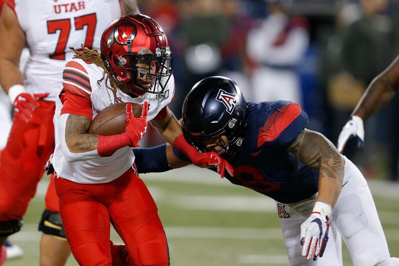 Utah wide receiver Derrick Vickers stiff-arms Arizona linebacker Anthony Pandy during game Saturday, Nov. 23, 2019, in Tucson, Ariz.