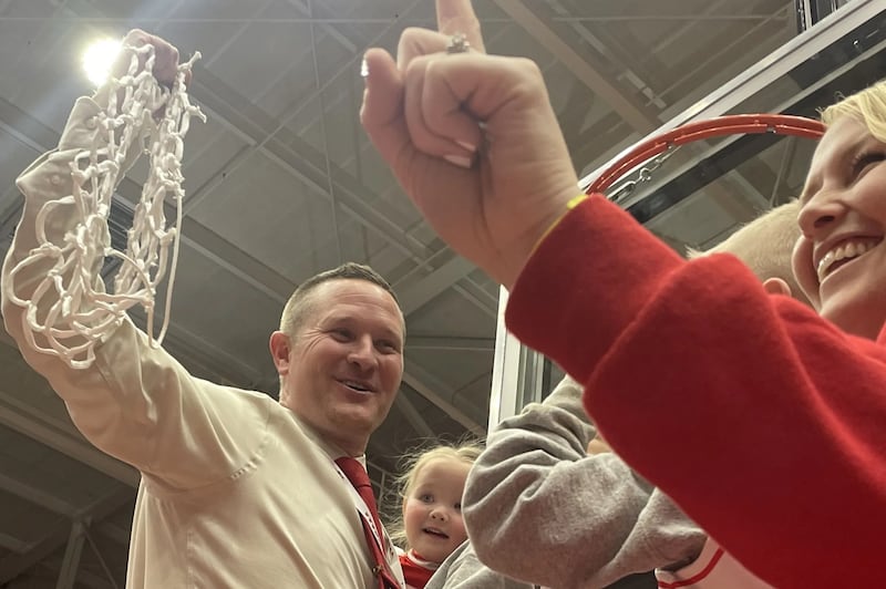 Manti coach Devin Shakespear holds the net up after the Templars’ state championship win.