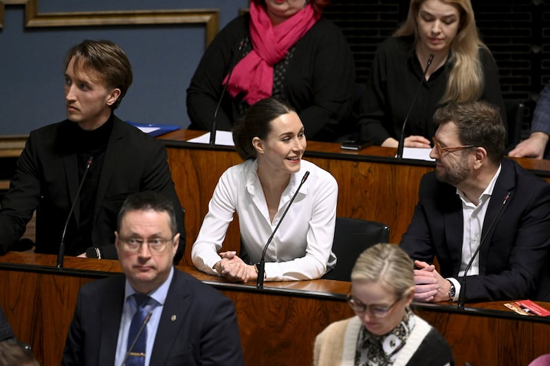 Parliament member Ilmari Nurminen, Finnish Prime Minister Sanna Marin, and Minister of Transport and Communications Timo Harakka attend the plenary session where Finnish Parliament voted on Finland’s accession to NATO in Helsinki, Finland