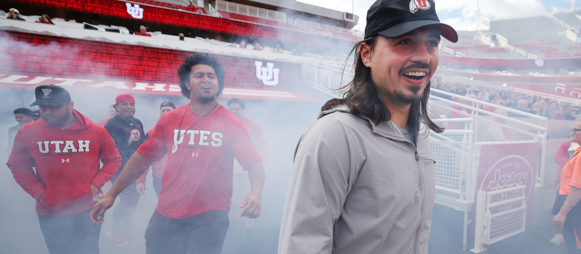 Utah quarterback Cam Rising at a Crimson Collective truck giveaway to scholarship players at Rice-Eccles Stadium.