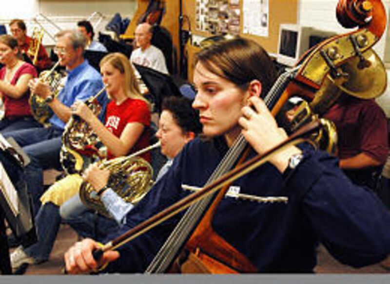 Nicole Smith plays the upright bass during a practice session with Salt Lake Symphonic Winds.