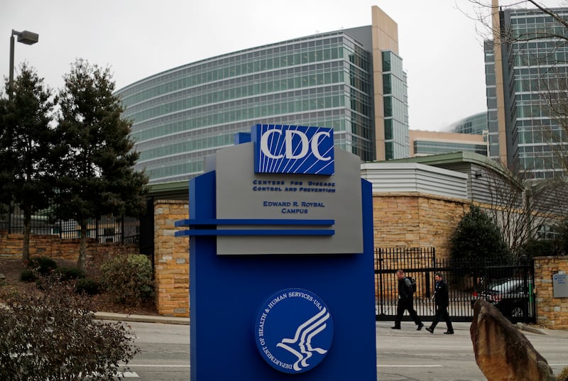 Pedestrians walk past the entrance for the U.S. Centers for Disease Control and Prevention on the third day of the government shutdown in Atlanta, Monday, Jan. 22, 2018. (AP Photo/David Goldman)