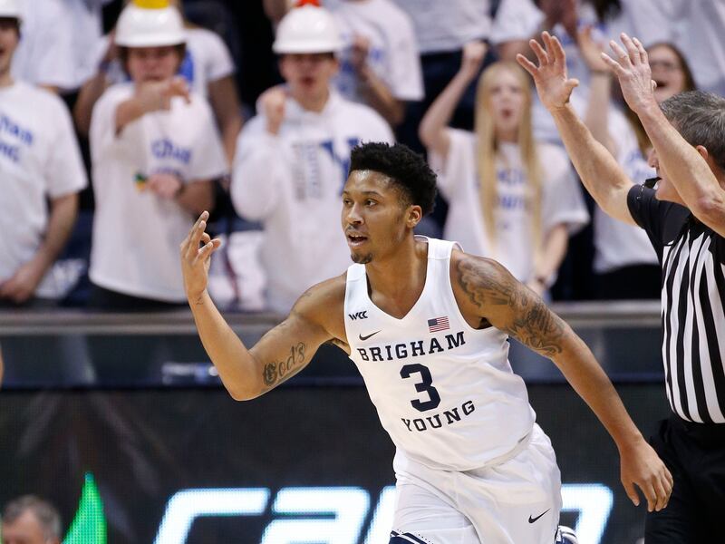 Brigham Young Cougars guard Te’Jon Lucas raises three fingers.
