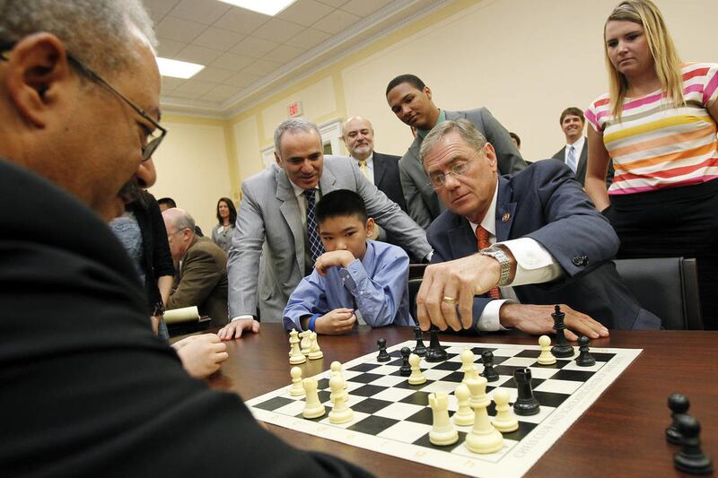 Left to right, Rep. Chaka Fattah (D-PA) and World Chess Champion Garry Kasparov watch Young Stars - Team U.S.A. player Jeffrey Xiong and Rep. Blaine Luetkemeyer (R-MO), make a move at the first-ever Congressional Chess Match at the Rayburn House Office Bu