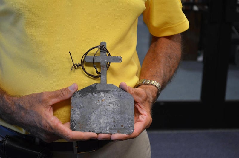 In this photo taken Wednesday, April 4, 2012, Ralph Coltrin shows a plaque that was used to mark a spot where Michael LaNoue died. Coltrin was on a hike with LaNoue four other Boy Scouts in 1958. LaNoue and two other Scouts died on the trip.