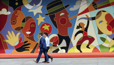 Pedestrians walk through McCarthy Plaza by Regent Street in Salt Lake City on Thursday, April 19, 2018.