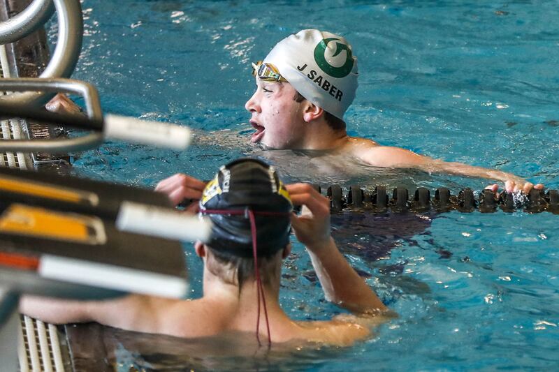 Olympus’ Jack Saber, shown here after winning last year’s 50-yard freestyle at the 5A state swim meet, posted the top qualifying time in Friday’s preliminaries of the 5A state swim meet.