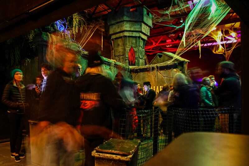 Employees scan tickets and put on wristbands at Nightmare on 13th in Salt Lake City on Saturday, Oct. 14, 2017.