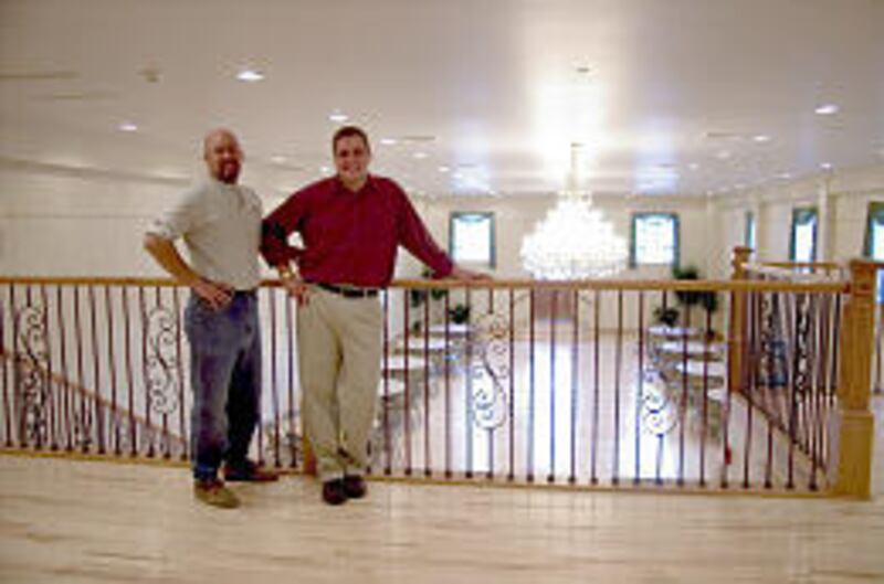 Gene Peckham, chairman of the Fountain Green Heritage Committee, and Fountain Green Mayor Scott Collard admire the town's newly restored dance hall.