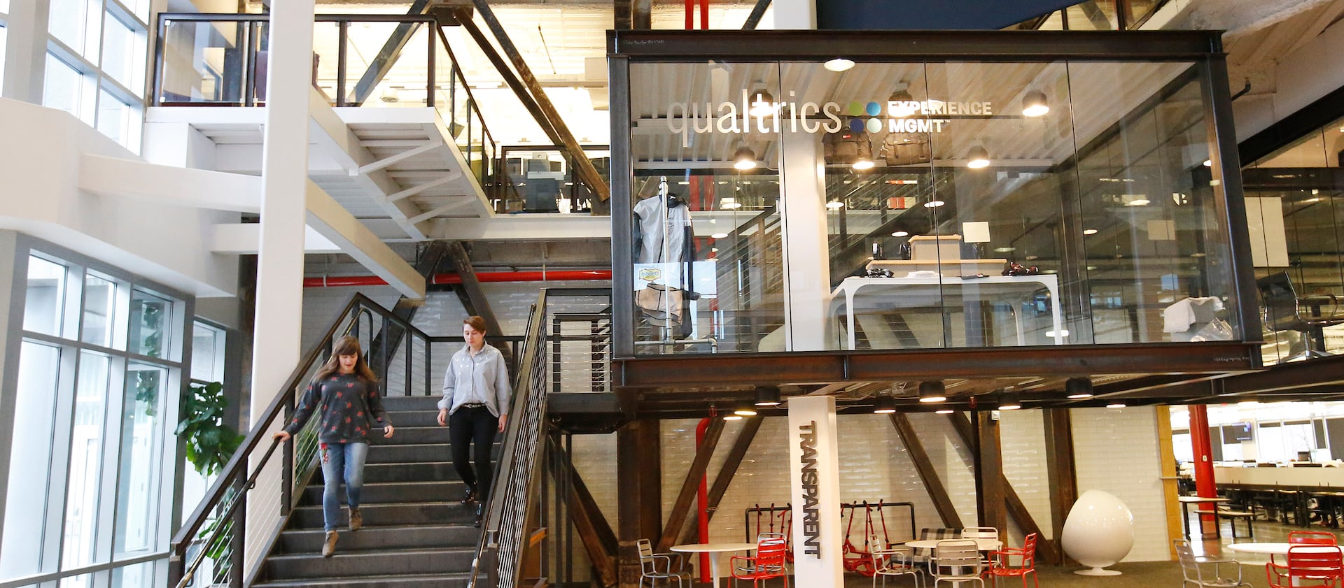 Qualtrics employees walk through the business in Provo on Feb. 2, 2018.