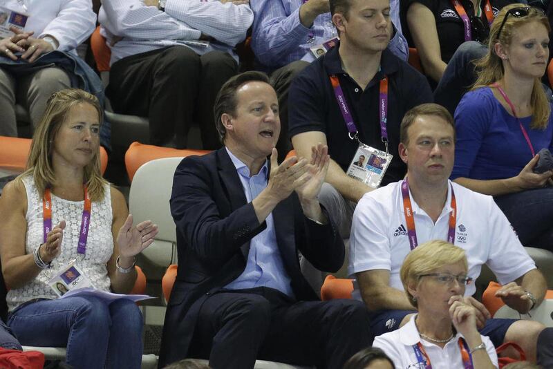 British Prime Minister David Cameron, center, applauds as he watches the Men's Synchronized 10 Meter Platform Diving final at the Aquatics Centre in the Olympic Park during the 2012 Summer Olympics in London, Monday, July 30, 2012.