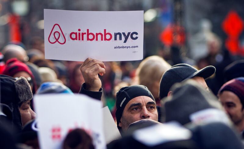 Supporters of Airbnb hold a rally outside City Hall in New York, Jan. 20, 2015. A New York judge on Tuesday, Aug. 8, 2023 dismissed lawsuits filed by Airbnb and three hosts over New York City’s rules for short-term rentals, saying the restrictions are “entirely rational.”