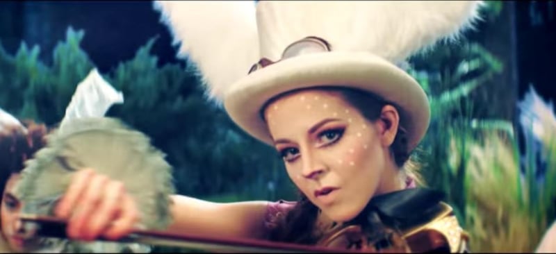 Lindsey Stirling plays her violin while dressed as the White Rabbit.