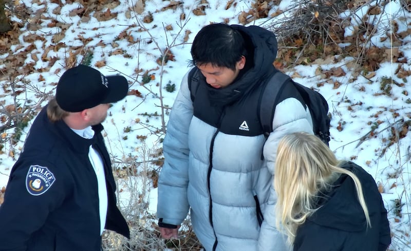 Law enforcement officials talk with Kai Zhuang, a 17-year-old Chinese exchange student, after he was found safe in a tent near Brigham City on Dec. 31, 2023.