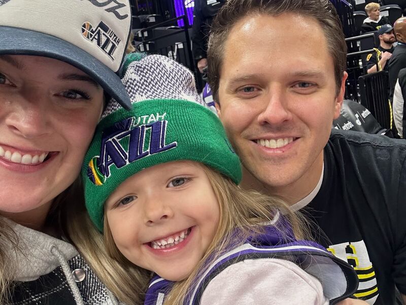 Ivorie Hadley, center, poses with her parents, Brett and McKenzie Hadley, at a recent Utah Jazz game.