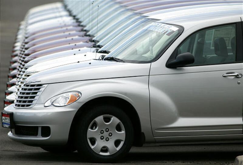 In this Aug. 26, 2007 file photo, a long row of unsold 2007 PT Cruisers sit on the lot of a Chrysler-Jeep dealership in the east Denver suburb of Aurora, Colo.