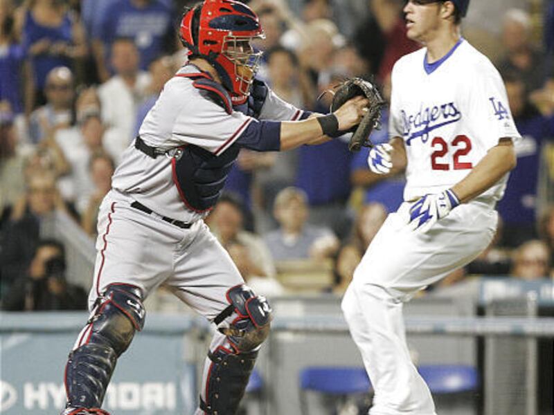 Los Angeles Dodgers' Clayton Kershaw is tagged out by Washington Nationals catcher Jesus Flores during the fifth inning in Los Angeles Wednesday. Dodgers' Manny Ramirez was safe at first on a fielder's choice.