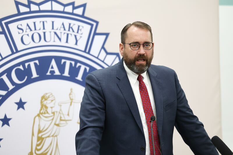 Utah County Attorney David Leavitt stands at a podium and speaks.
