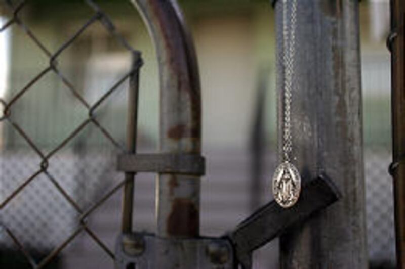 A religious emblem hangs from the fence of the home in west Salt Lake where gunman Sulejman Talovic is believed to have lived. A neighbor placed it there.