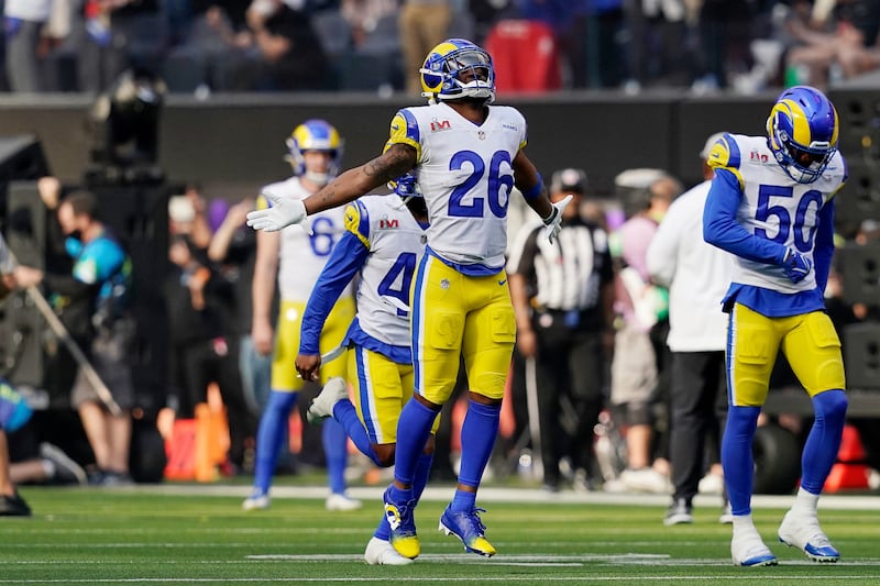 Los Angeles Rams defensive back Terrell Burgess, wearing white, runs out on the field