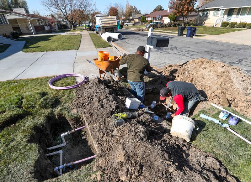 Ormond Construction crews install secondary water meters in a subdivision in Woods Cross.