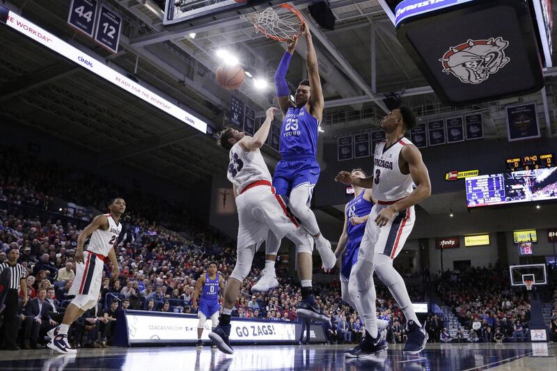 BYU forward Yoeli Childs (23) dunks over Gonzaga forward Killian Tillie (33) during the first half of an NCAA college basketball game in Spokane, Wash., Saturday, Feb. 3, 2018. (AP Photo/Young Kwak)