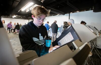 FILE - Grace Laughlin a first time voter casts her ballot at a Polling station at Trolley Square in Salt Lake city on Tuesday, Nov. 6, 2018.