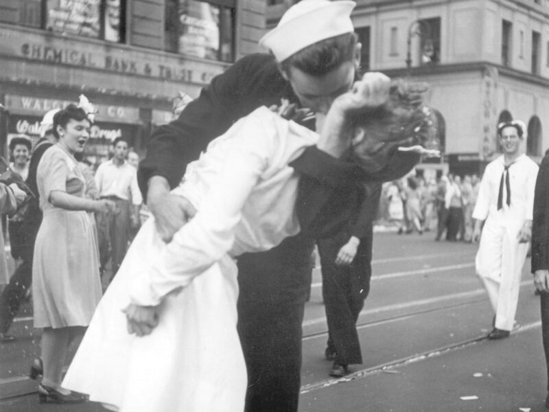 FILE - In this Aug. 14, 1945 file photo provided by the U.S. Navy, a sailor and a woman kiss in New York's Times Square, as people celebrate the end of World War II. The ecstatic sailor shown kissing a woman in Times Square celebrating the end of World Wa