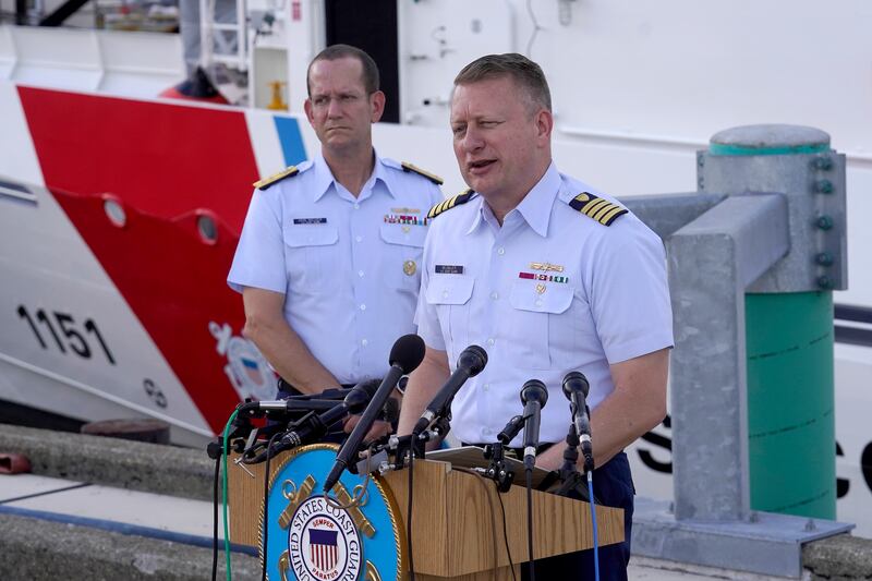 Capt. Jason Neubauer, chief investigator, U.S. Coast Guard, speaks with the media as Rear Adm. John Mauger, commander of the First Coast Guard District, looks on during a news conference, at Coast Guard Base Boston.