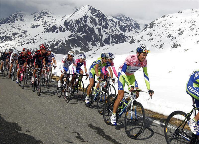 Italy's Ivan Basso, right, wearing the pink jersey of the overall leader, pedals with the pack as they climb the Gavia pass during the 20th and penultimate stage of the Giro d'Italia cycling race Saturday. Basso has won the Giro for the second time.