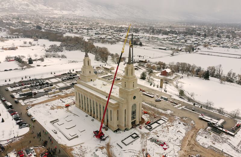 An aerial view of the Layton Utah Temple as a crane places the Angel Moroni statue atop the front spire on Wednesday, March 9, 2022.
