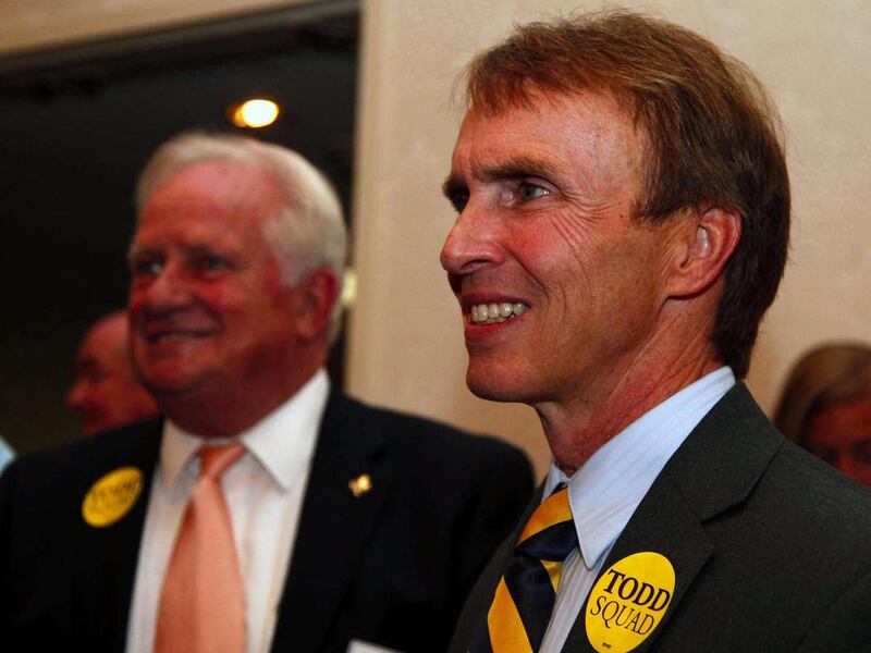 Kentucky State Treasurer Todd Hollenbach III stands with his fatther, former Jefferson County judge executive Todd Hollenbach, at the Capital Plaza in Frankfort, Ky., Tuesday May 17, 2011. Hollenbach won the Democrat primary race for state treasurer again
