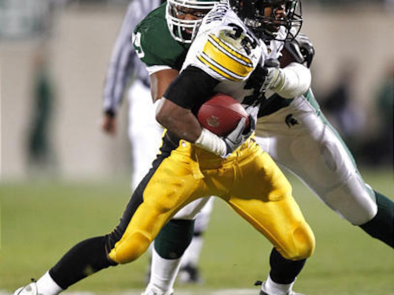 Iowa's Adam Robinson (32) is stopped Michigan State's Jerel Worthy during the second quarter.